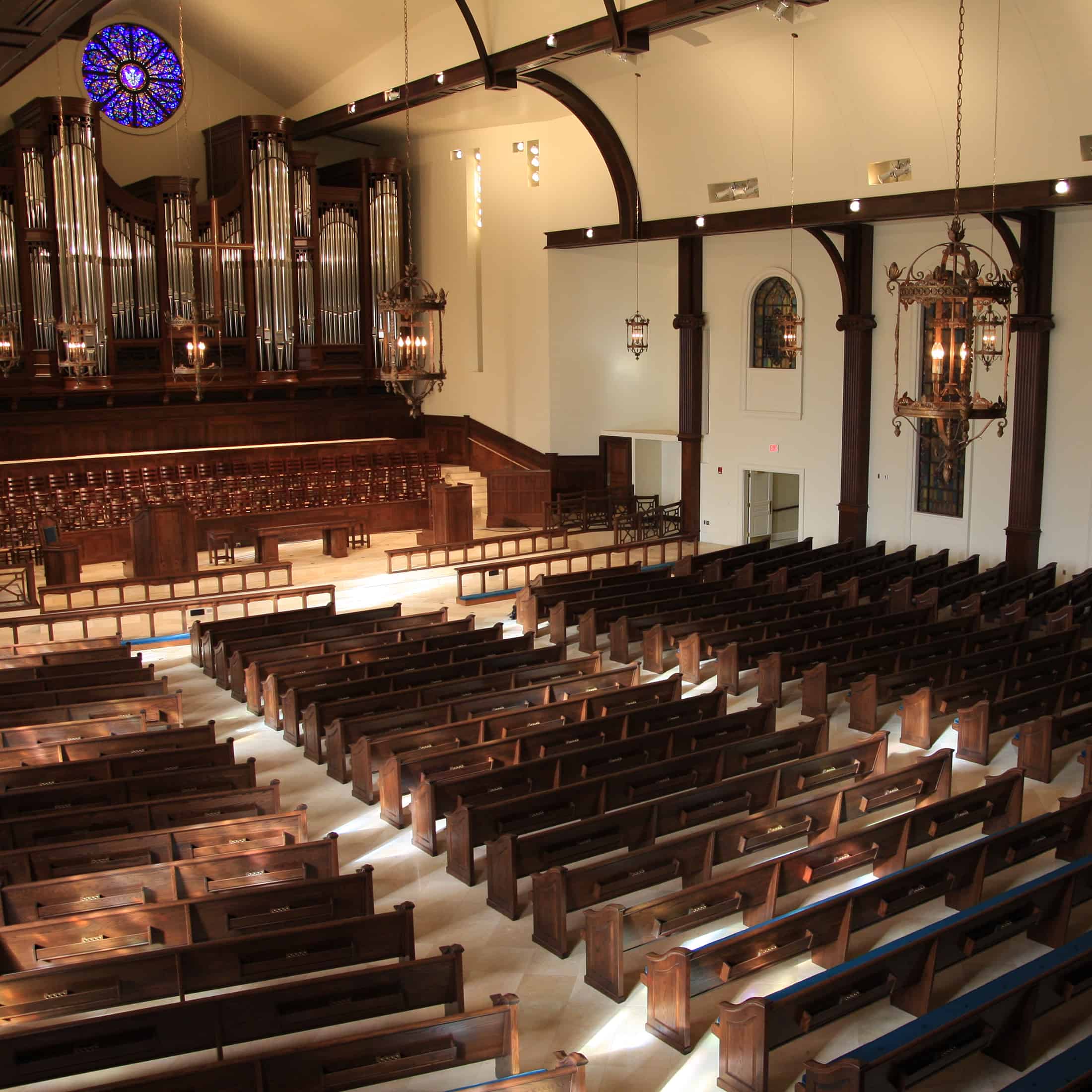 Interior view of Christ United Methodist Church located in Louisville, KY with Upholstered Seat and Wood Back Pews
