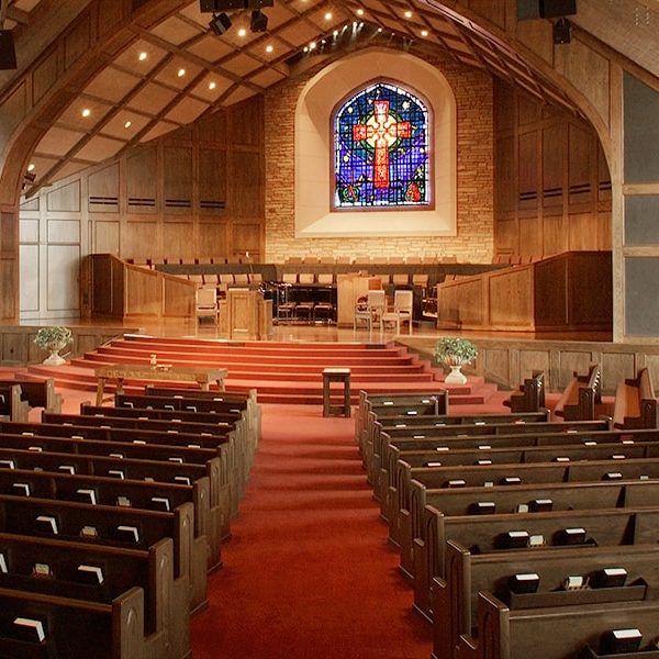 Interior of First Presbyterian Church located in Edmond, OK with Upholstered Seat and Wood Back Pews