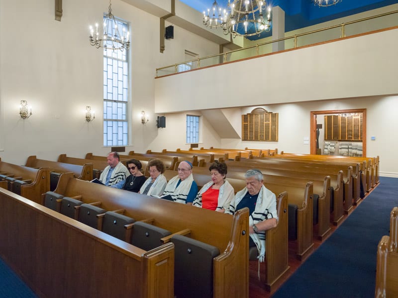 Or Olam Synagogue with people in pew row