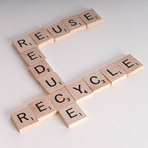Reduce, Reuse, Recycle concept.  Wooden Scrabble letters spell out "reduce, reuse, recycle" Isolated on white background