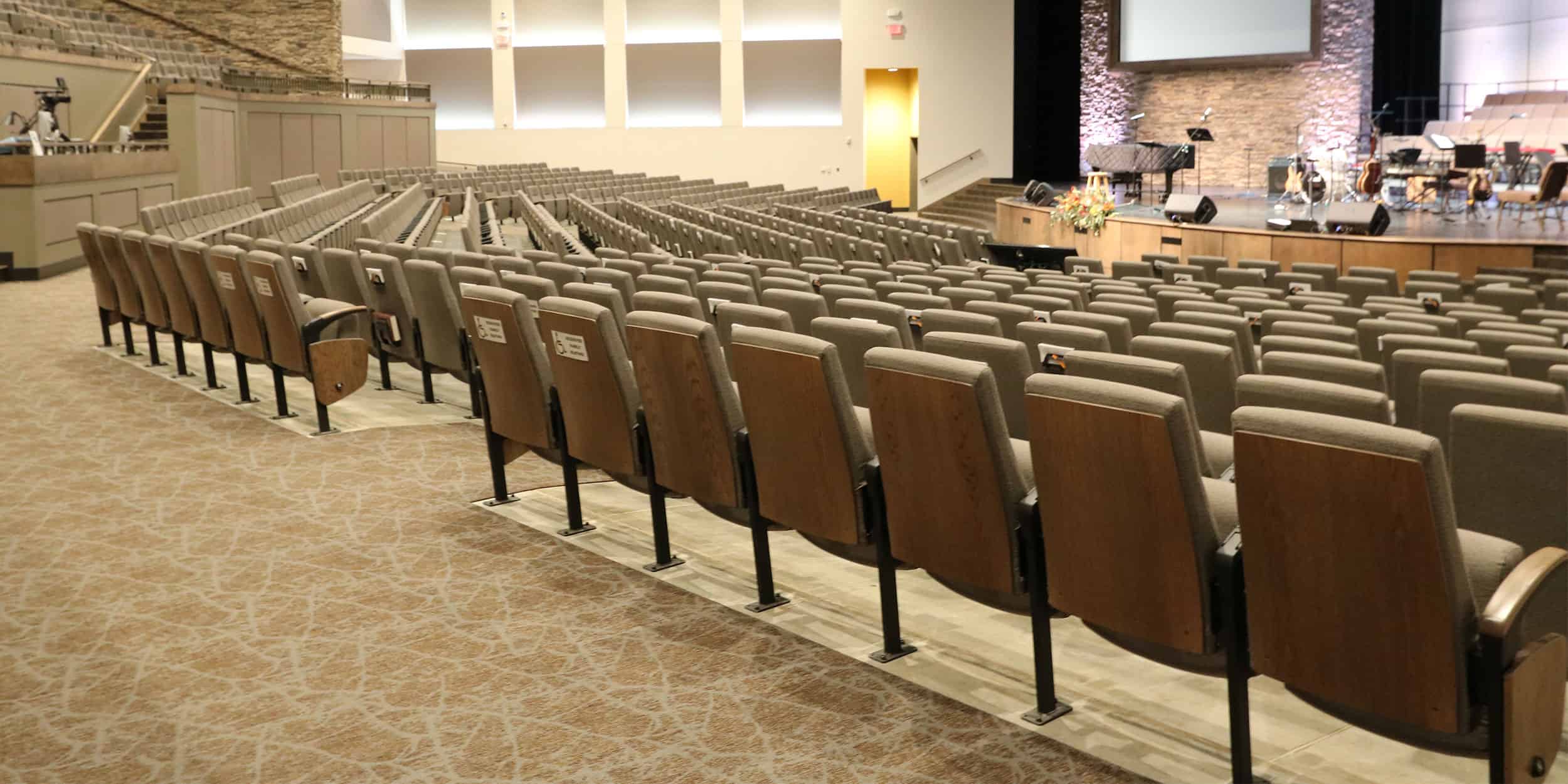 Auditorium seats with wood backs in a house of worship