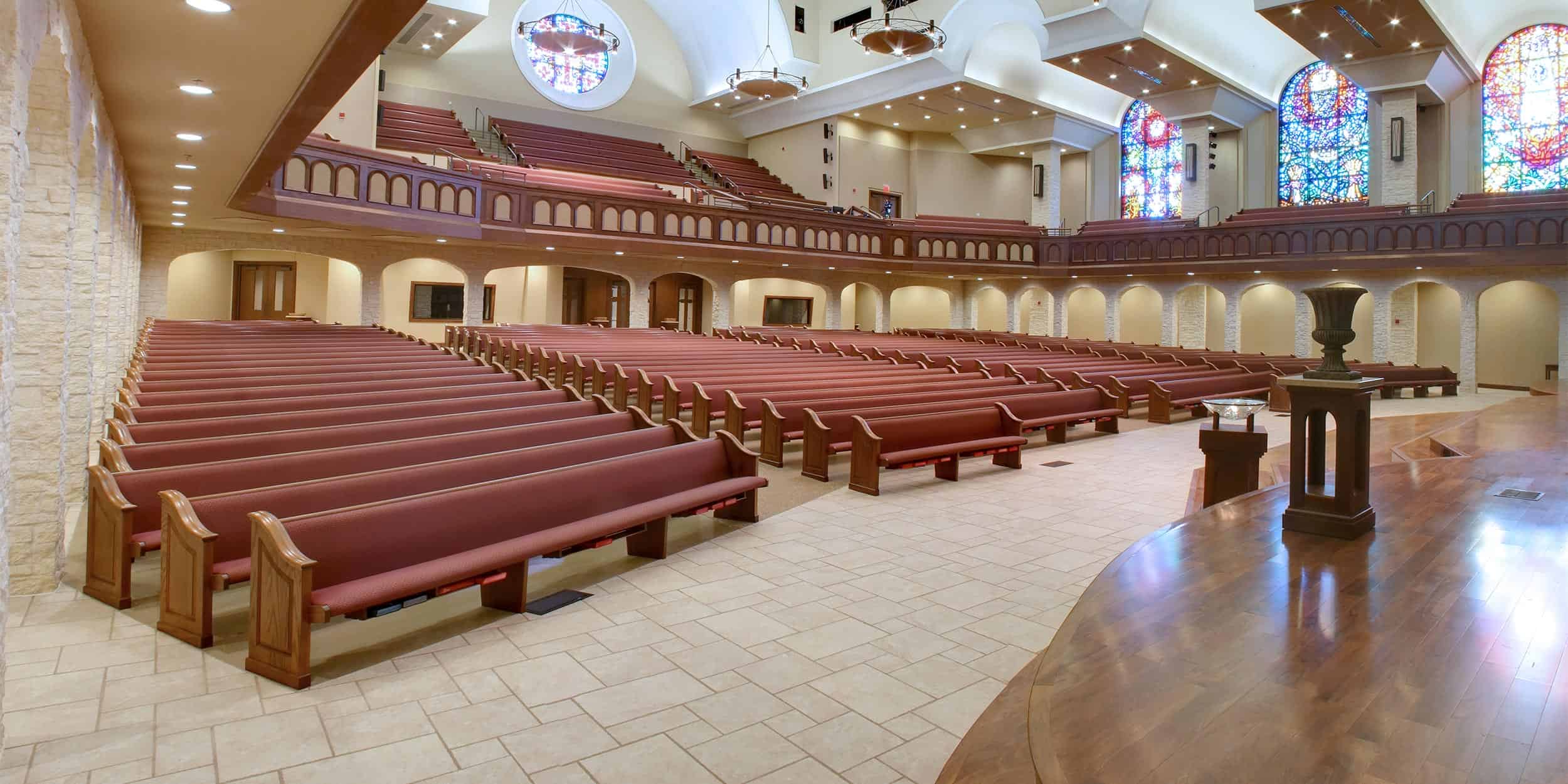 Fully upholstered church furniture including pews from Sauder.