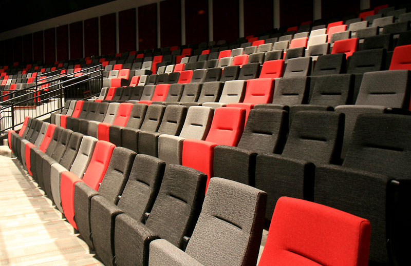 Clarity® Auditorium Seating from Sauder Worship Seating in various colors of red, black, and gray.