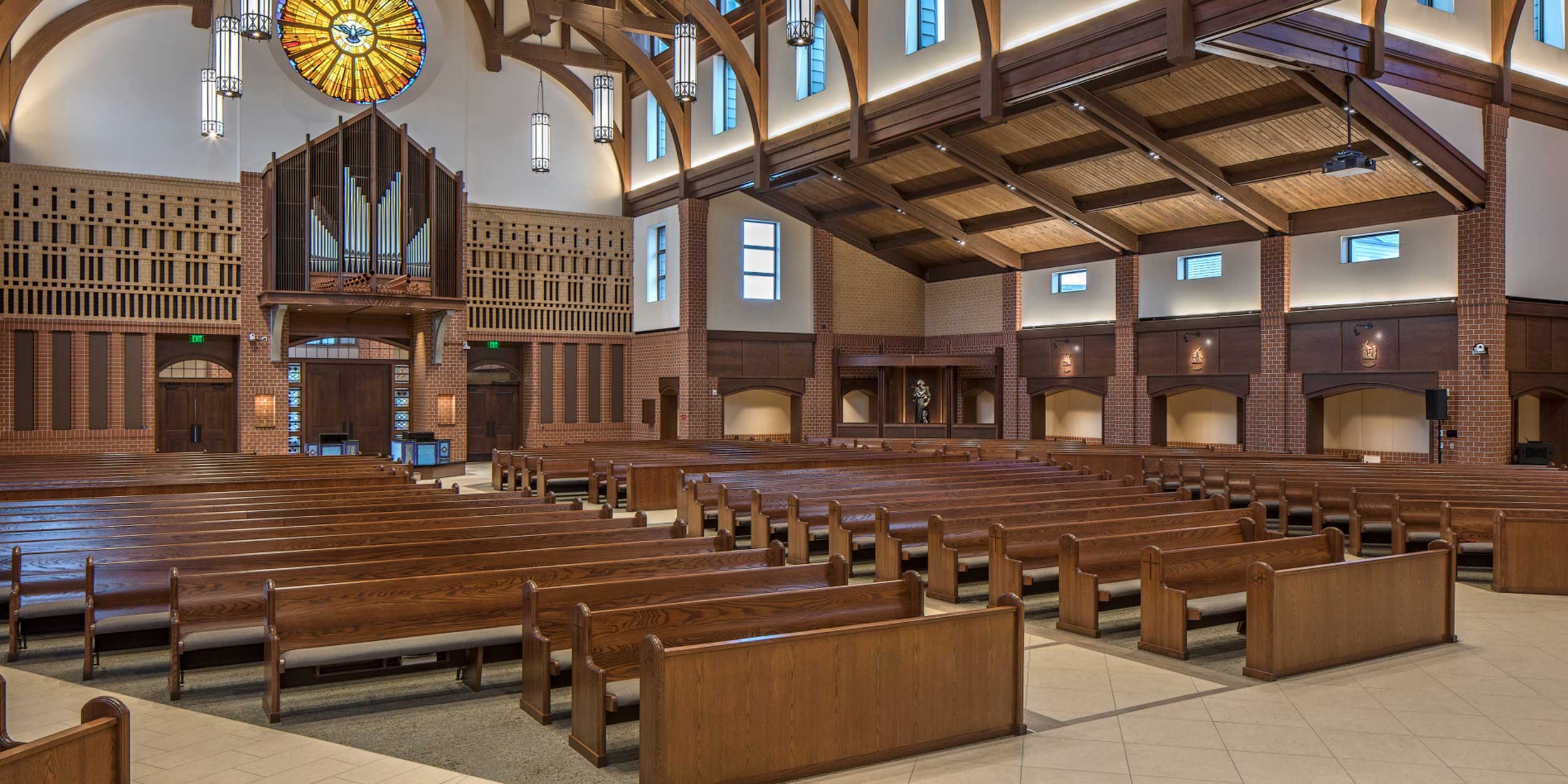 Wood pews with upholstered seats and wood frontals from Sauder Worship Seating